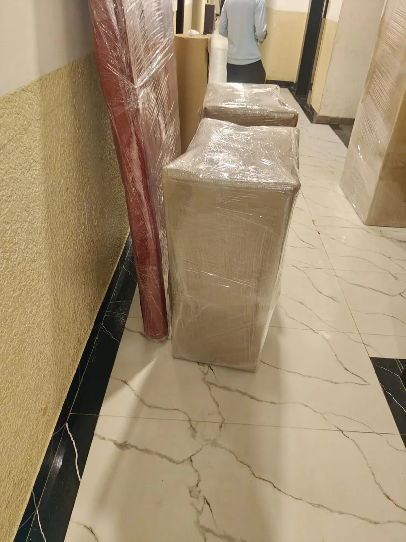 Household furniture in protective wrapping, supplied Om Sai packing photograph